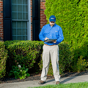 mosquito control specialist inspecting