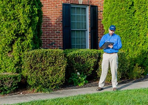 A Professional Rodent Inspection Will Identify The Issues a service technician performing an exterior inspection in elkridge maryland