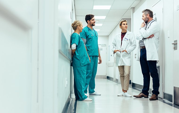 a doctor talking to staff members at a hospital