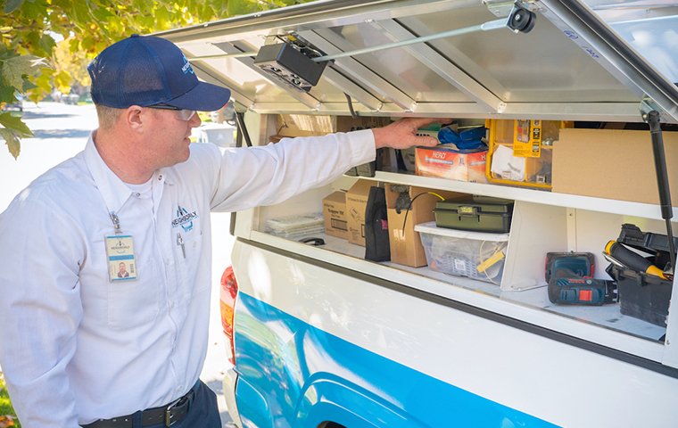 a pest technician preparing to do a follow up visit