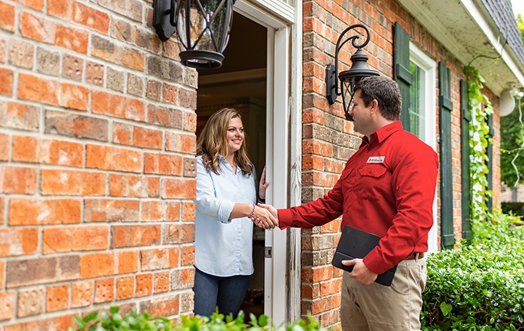 Home Pest Control a pest control service technician greeting a residential homeowner in norco california