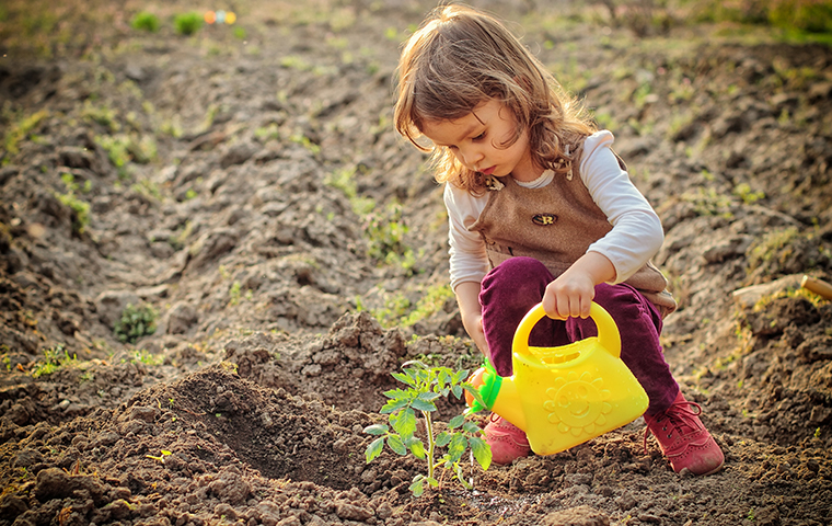 We Use Products That Are Safe For The Environment little girl playing in the dirt