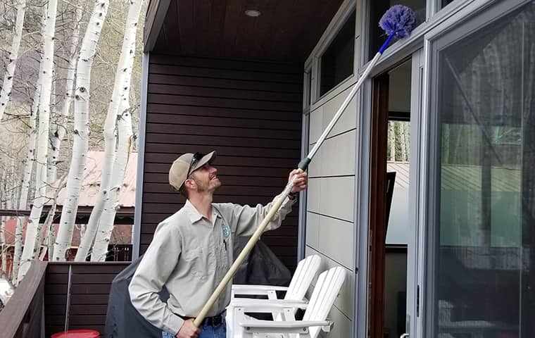 We Promise A Solution For Any Pest Problems a ram wildlife and pest management service technician treating a home in de beque colorado
