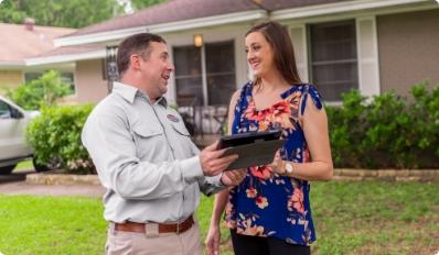 romney pest control tech explaining reporting to homeowner