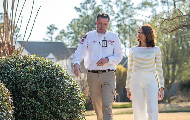 tech inspecting property with homeowner