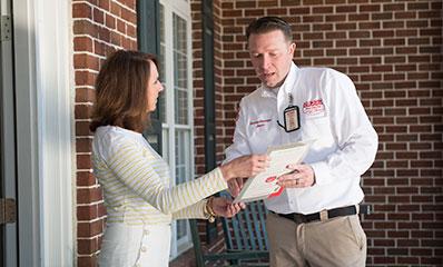 tech giving a report to the homeowner