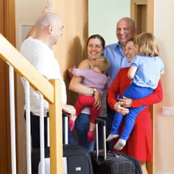 Have Family And Friends Over Without Worrying About Pests Like Mice, Spiders And Bed Bugs family being welcomed at door