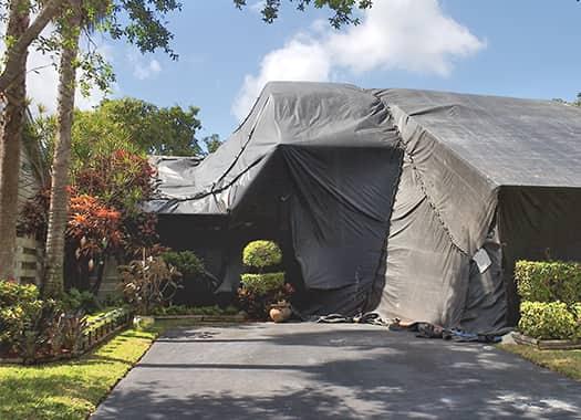 Learn More About Fumigation Treatments Today a home in evansville indiana fully tented for pantry pest fumigation on a sunny summer day