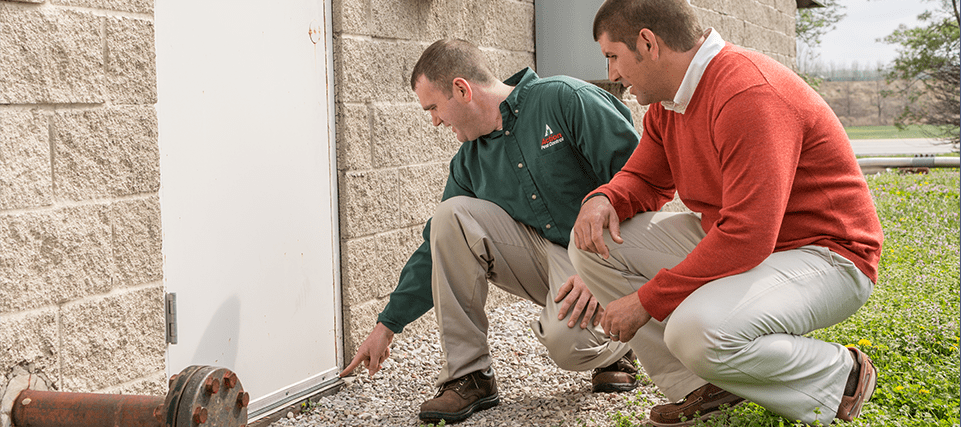 Commercial Pest Control Services commercial technician inspecting facility with manager