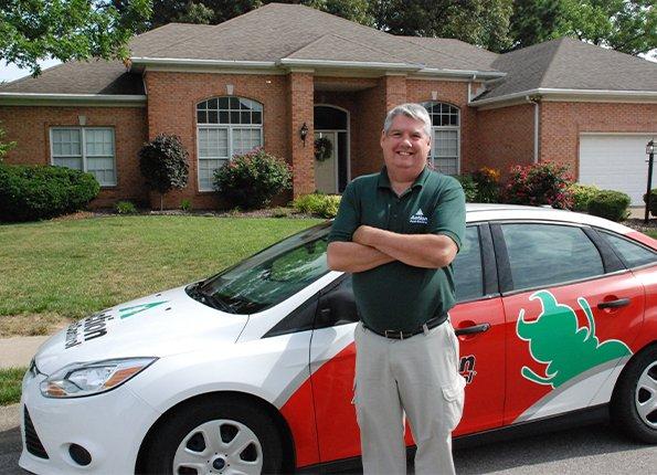 Interior Home Pest Control Services pest technician in front of company car