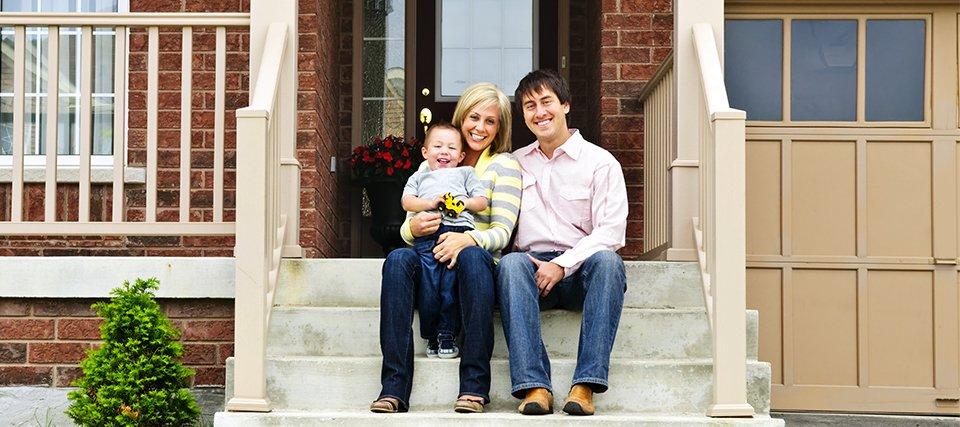 Comprehensive Home Pest Control homeowners sitting on front steps of home