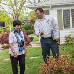 pest control technician talking to customer