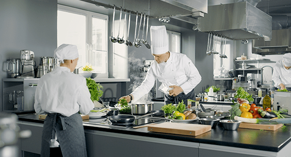 people cooking in commercial kitchen