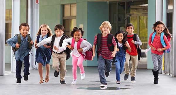 children running out of school