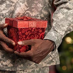 military service member holding present