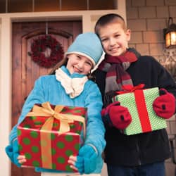 kids holding presents out their home