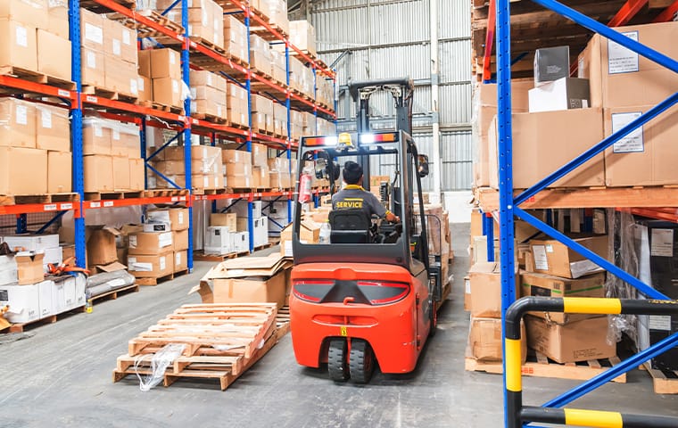 a warehouse interior with stacks of products in boxes in prosper texas