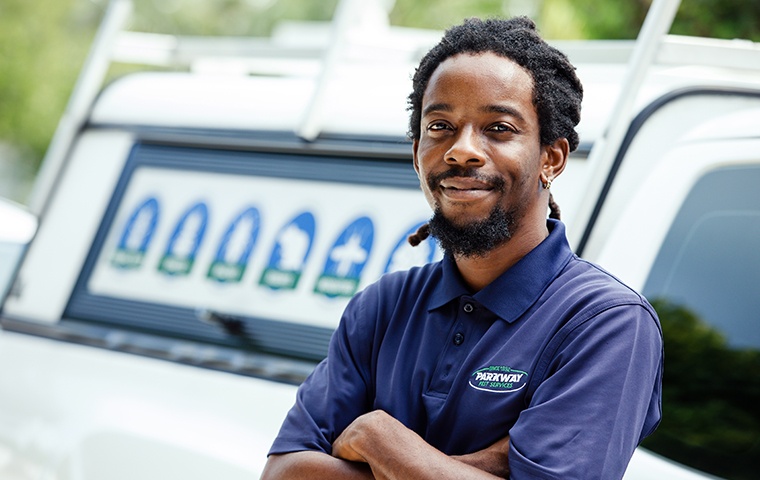parkway pest solutions technician outside of a property on grand turk island