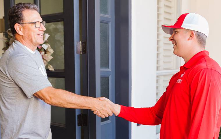 technician shaking hands with a homeowner in mesa arizona