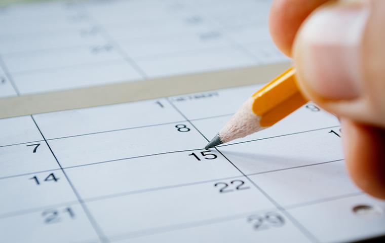 person marking a date on a calendar in tarrant county