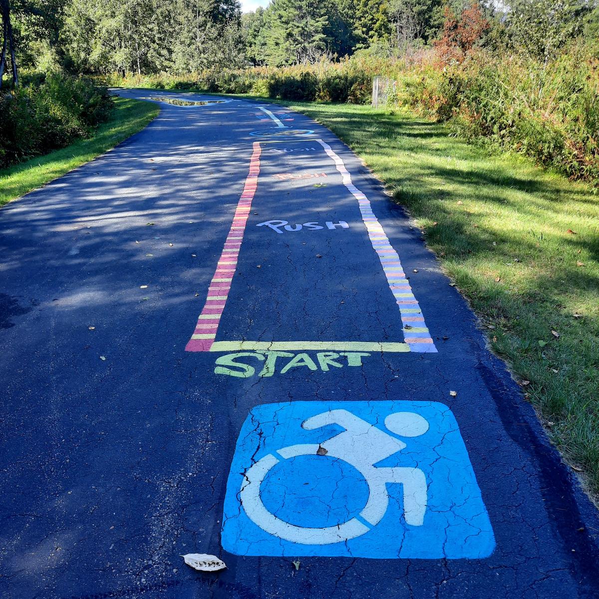A adventure course for wheelchairs is chalked in at teh beginning of the Bethel Pathway