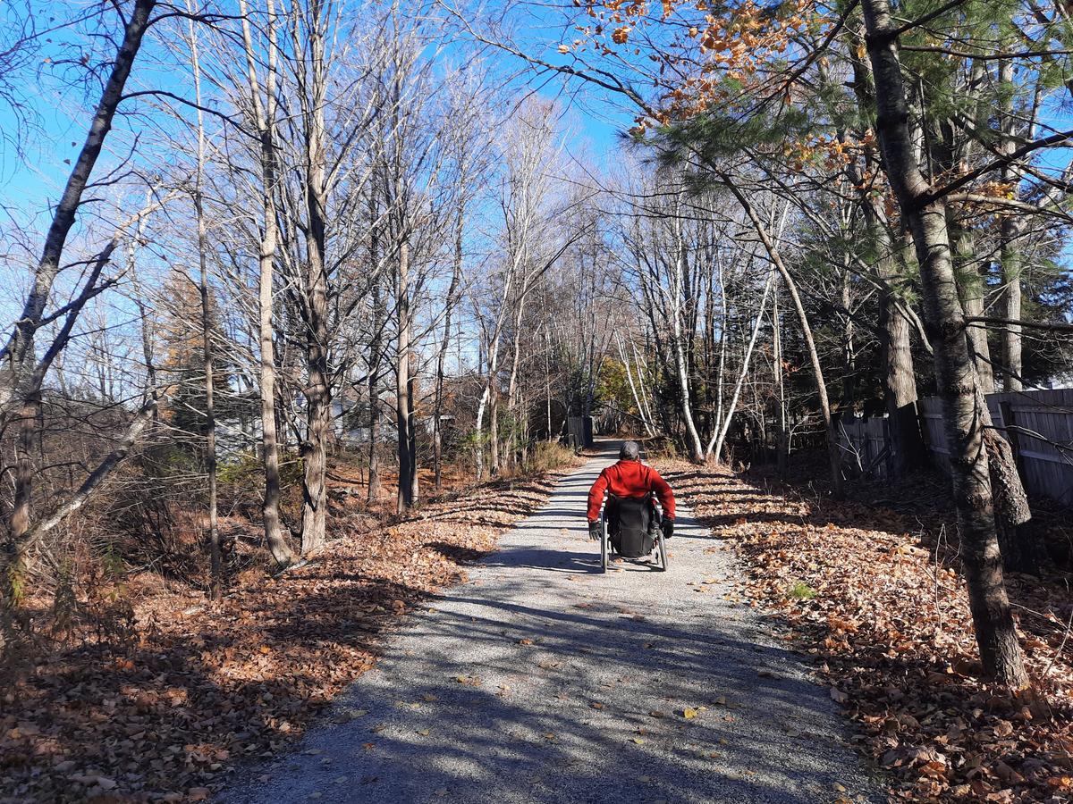 Enock on the wide, flat, packed gravel surface of the Norway Rail Trail. Photo credit: Enock Glidden