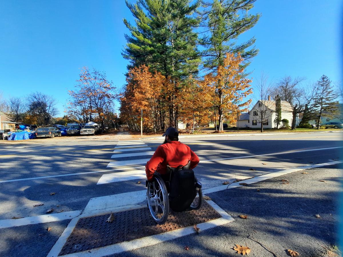 Enock at one of the road crossings on the Norway Rail Trail. Photo credit: Enock Glidden