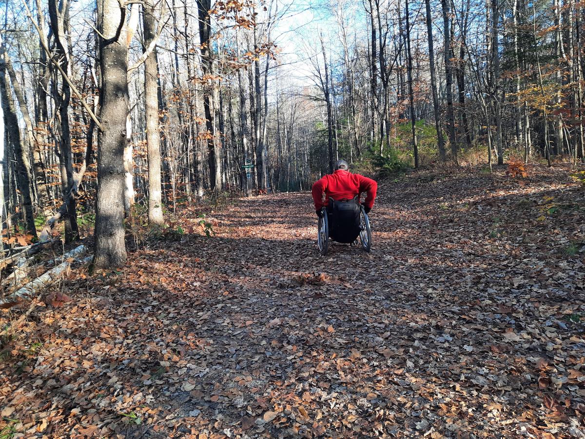 Enock pushing up the hill on the Libby Trail. Photo credit: Enock Glidden