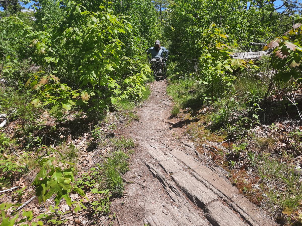 Enock getting through another challenging section of trail.