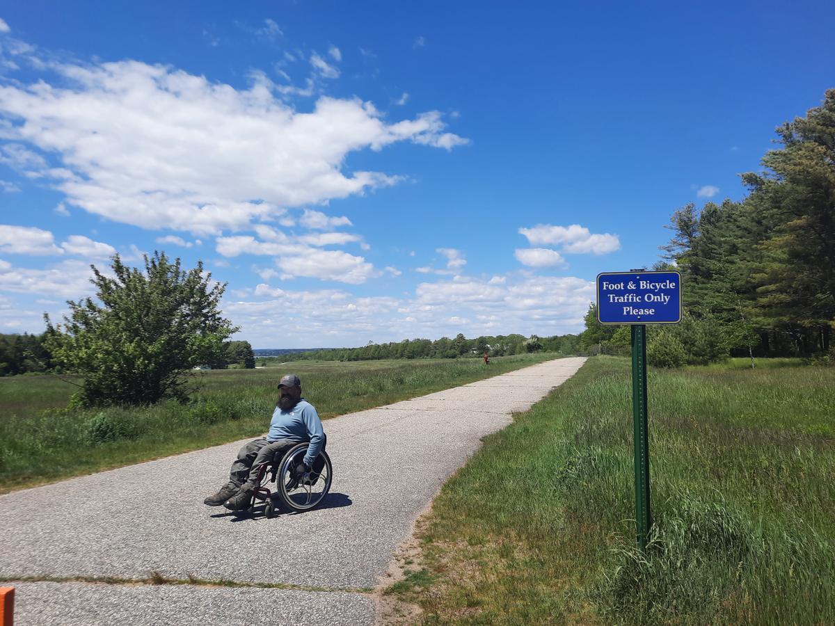 Enock at the entrance to the George J. Mitchell field trail.