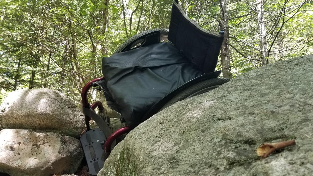 Enock's wheelchair on its way over the rock wall.