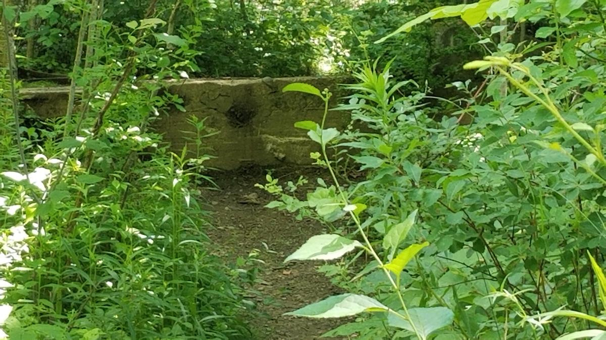 Giant block of concrete blocking the trail.