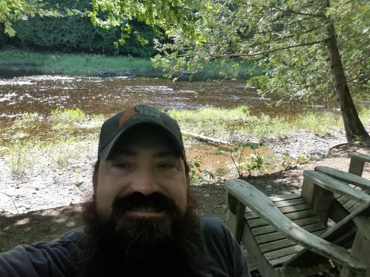Enjoying the view of the river at the end of the trail (next to more Adirondack chairs).