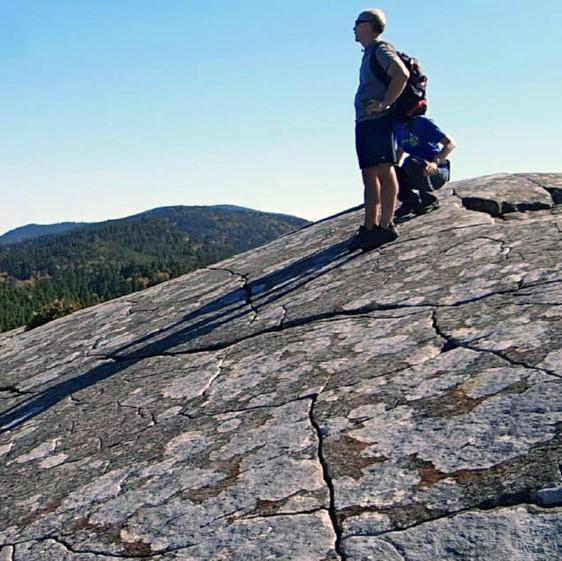 Hikers on an exposed rock face