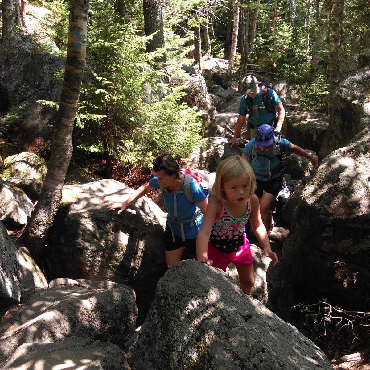 hikers climbing up a rocky trail