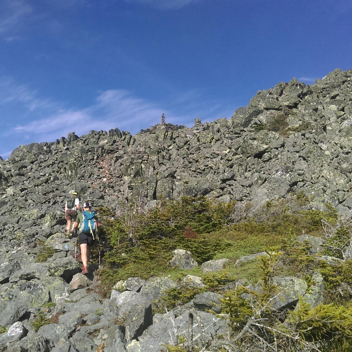 hikers climb an extremely rocky section