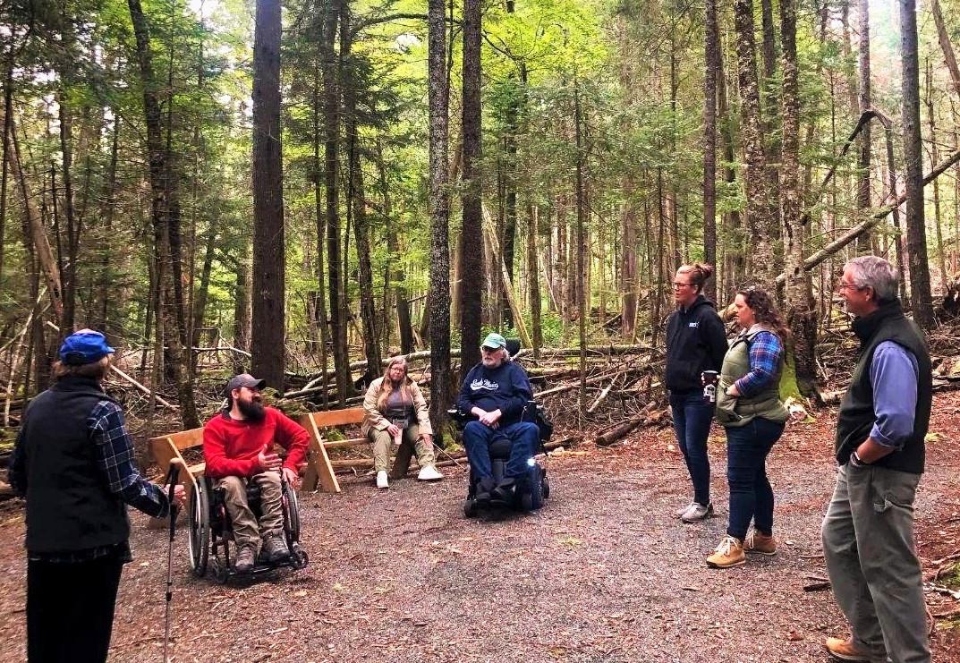 Talking about MTF by the moss-covered boulders at the end of the accessible trail.