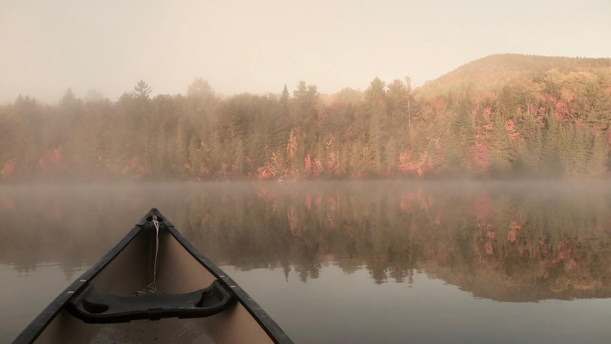 The chill quiet of cool mornings is broken only by the dip of your paddle as summer turns to fall. Pogy Pond, Baxter State Park.