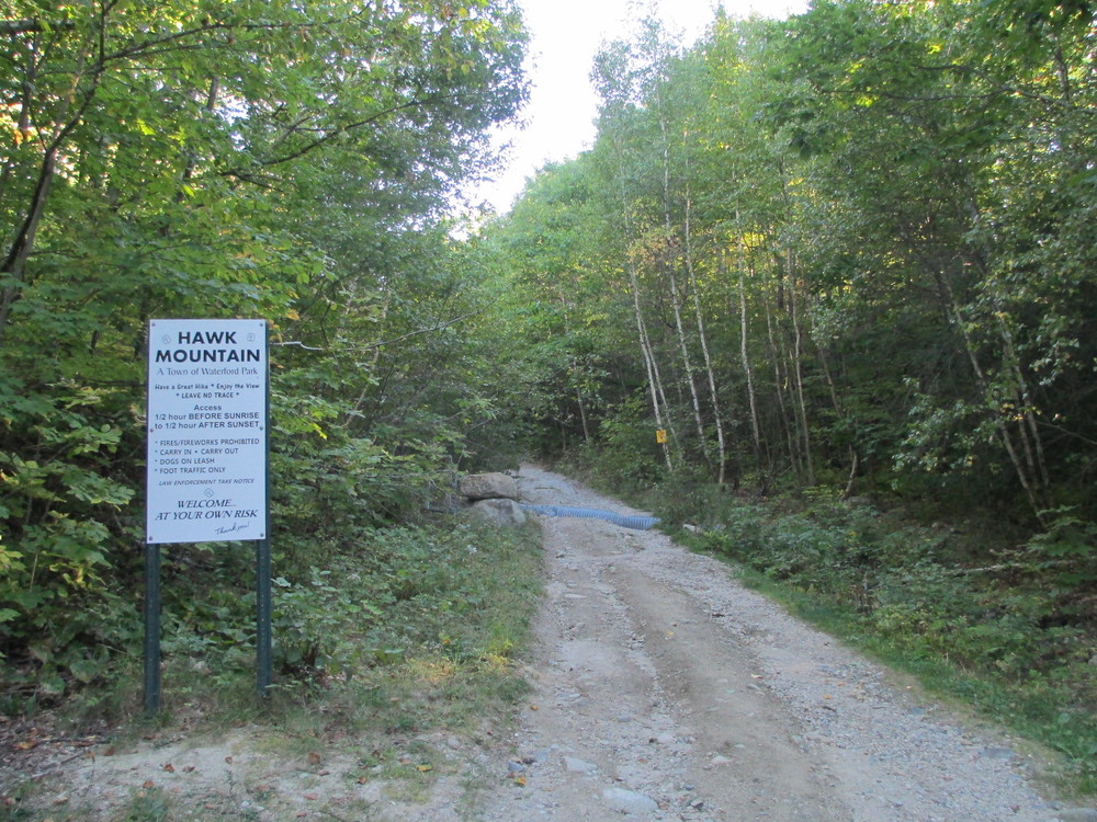 Hawk Mountain trailhead. The sign is outdated; the property was recently acquired and is now managed by Western Foothills Land Trust (Credit: Maine Trail Finder)
