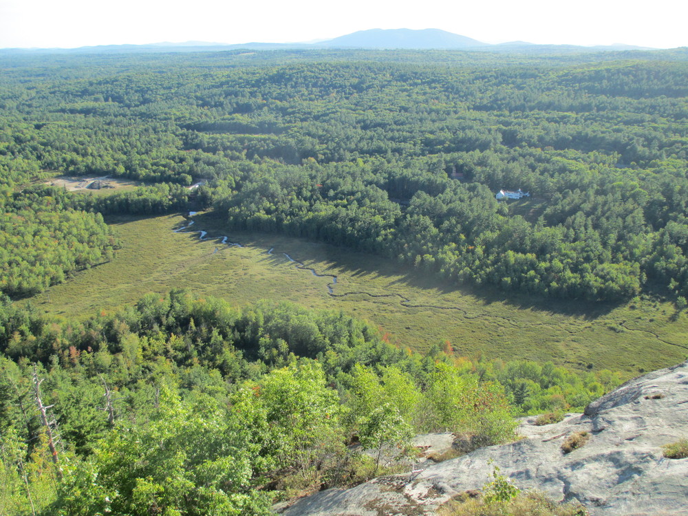 The cliffs on Hawk Mountain overlook this wetland (Credit: Maine Trail Finder)