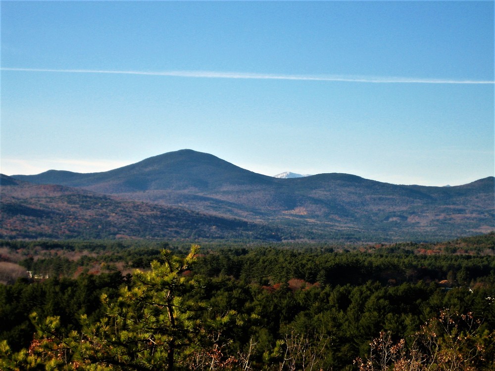 Snowcapped peaks in the White Mountains are just visible to the northwest (Credit: Maine Trail Finder)