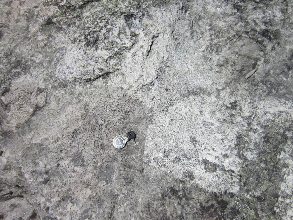 At summit, large feldspar crystals (white) and porphyritic aplite (left). Note graphic texture in feldspar crystals