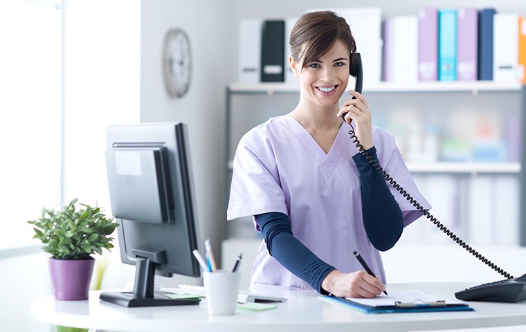 a hospital receptionist on the phone