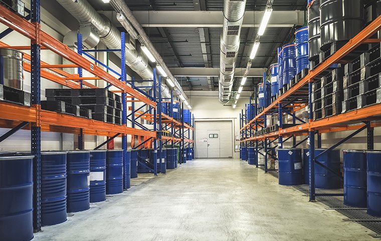 a large warehouse with barrels on tall shelves