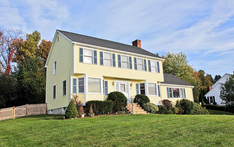 Avoid Expensive Repairs With Our Termite Control Service street view of a two story yellow house in hamden connecticut