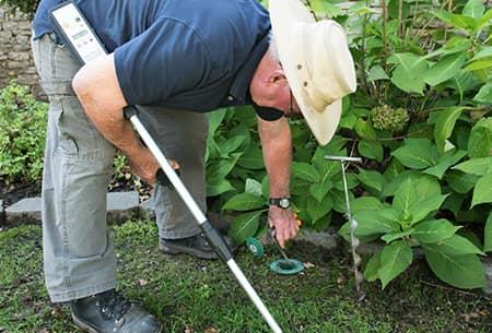Protect Your Home All Year Long With Sentricon technician checking termite bait station