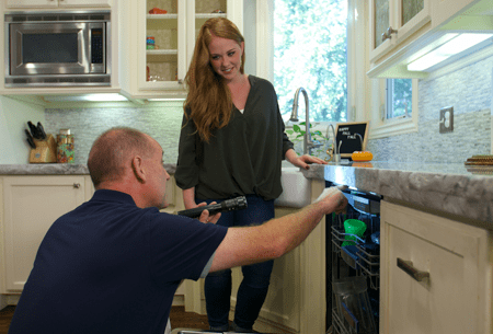 Protect Your Home And Family From Tulsa Area Pests technician inspecting kitchen