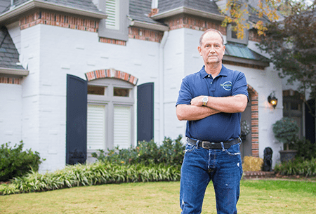 technician in front of a tulsa home