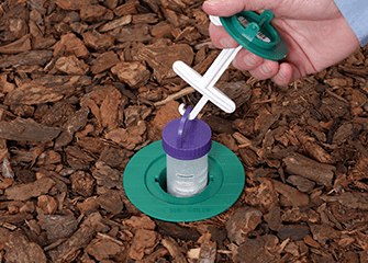 Monitoring Bait Stations For Maximum Effectiveness tech monitoring a termite station