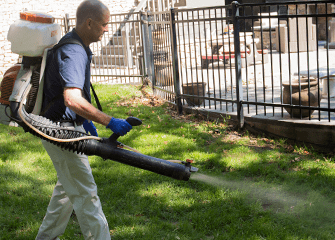 montgomery exterminating tech treating yard for fleas and ticks